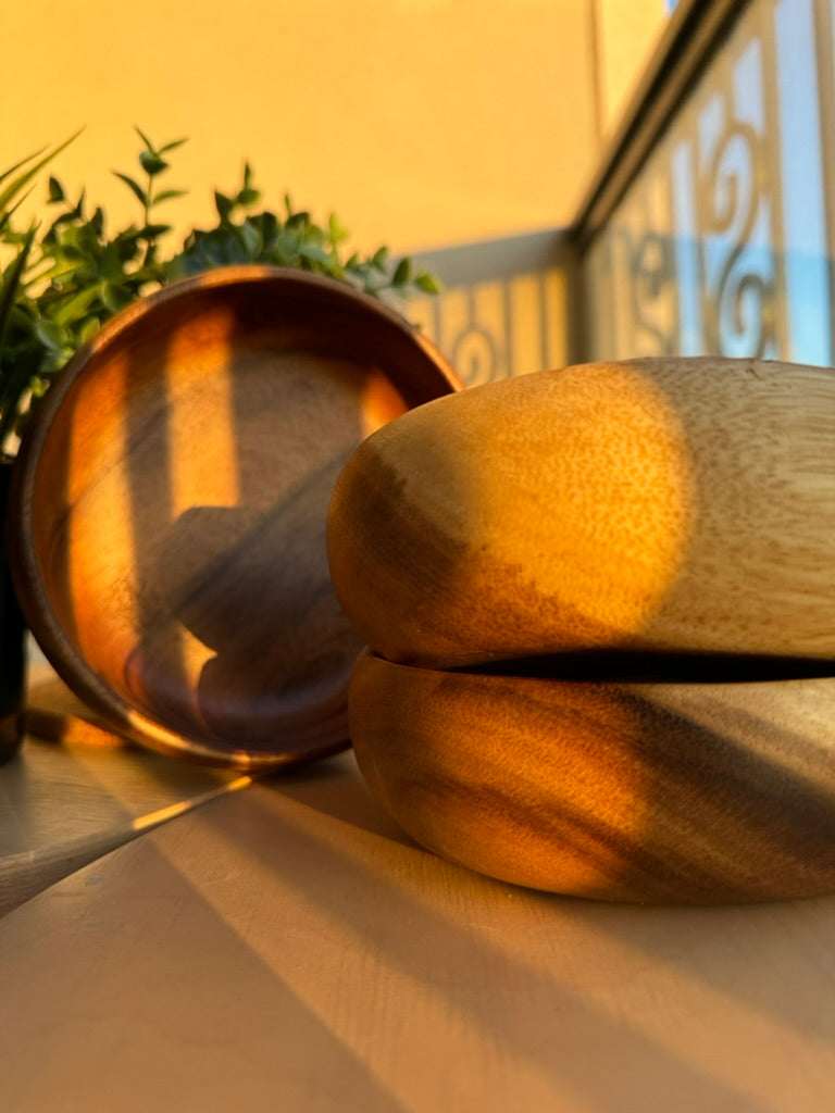 Elegant set of bowls made from Acacia wood, highlighting diverse grain textures.